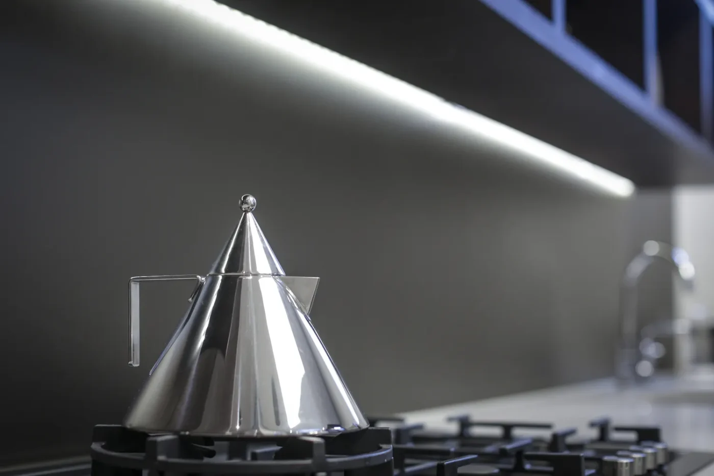 A modern kettle on a stovetop part of a sleek kitchen design