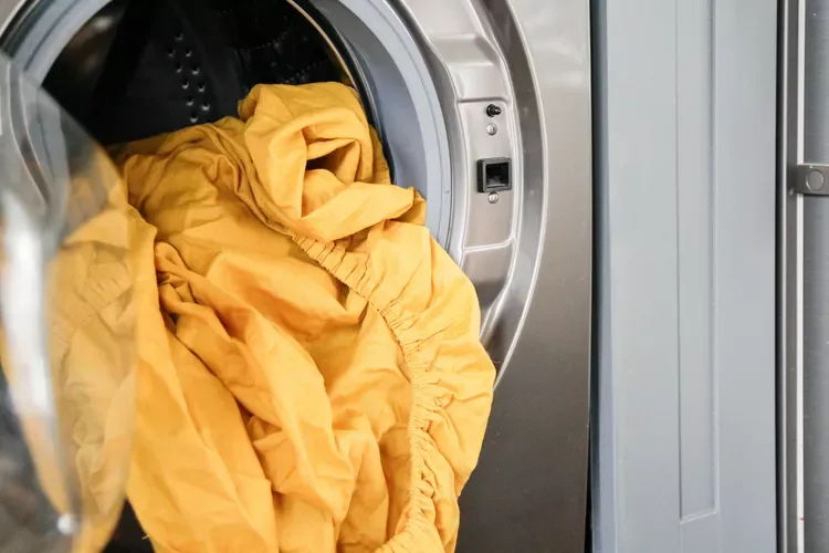 yellow sheets hanging out of dryer