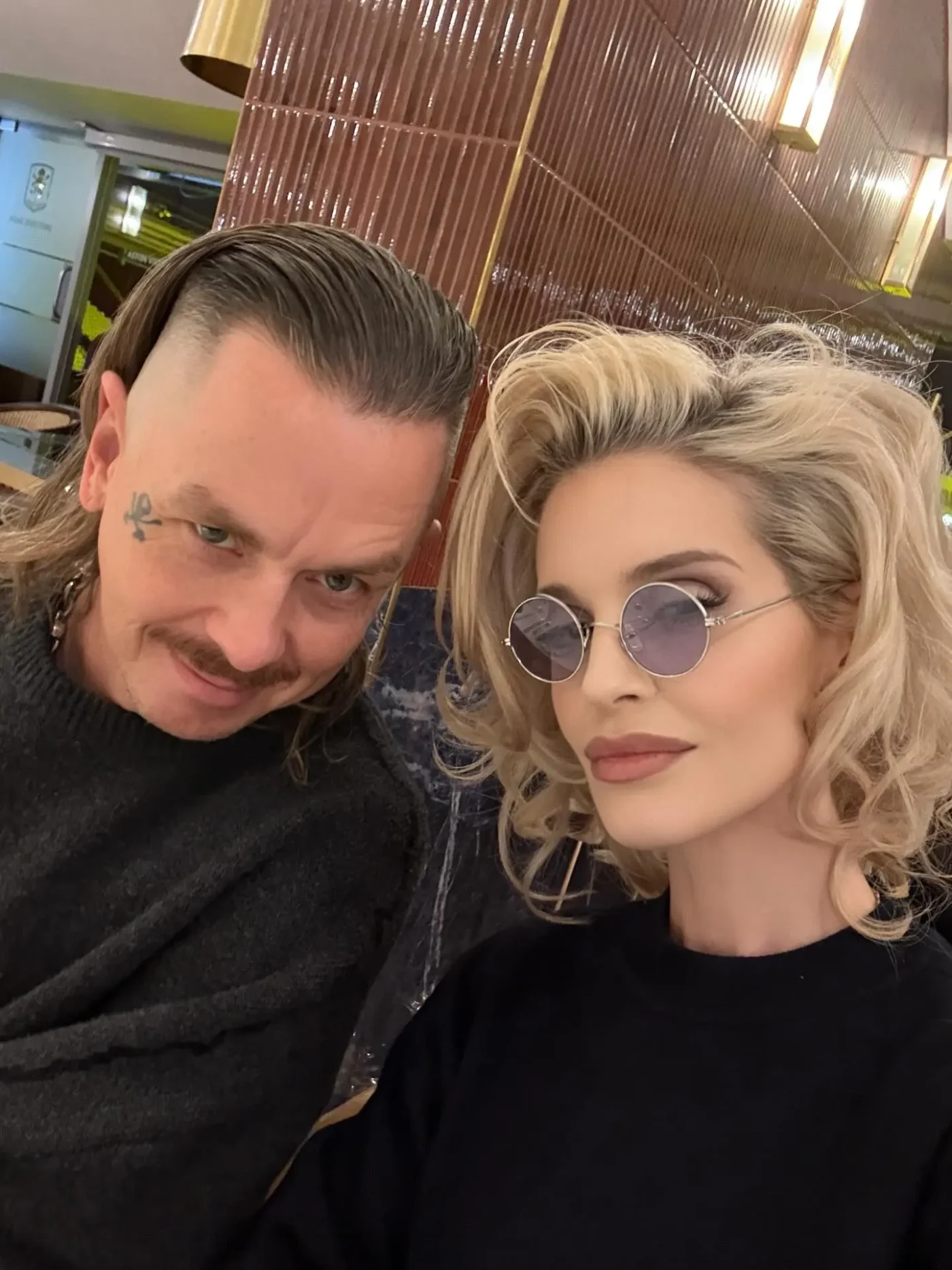 Kelly Osbourne and Sid Wilson posing together.